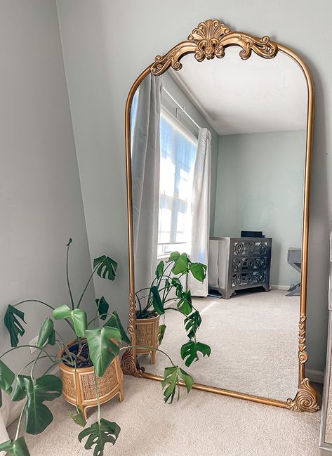 <p>Add inviting appeal to your space with our <strong>Vintage Inspired Floral Arched Wall Mirror</strong>. Drawing its inspiration from the past, this arched mirror is full of vintage charm, with its distressed gold finish, curved frame, and decorative floral detailing. Reflect your style beautifully in any room with this decorative accent mirror.</p> Big Vintage Mirror Living Rooms, Gold Mirror For Bedroom, House Mirror Ideas, Vintage Floor Mirror Bedroom, Accent Mirrors Bedroom, Over Dresser Mirror, World Market Mirror, Gold Vintage Living Room, Huge Gold Mirror