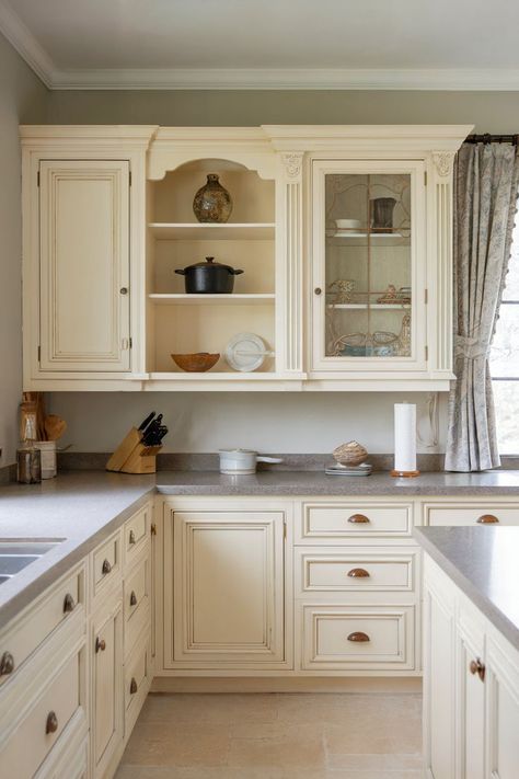 A cream kitchen cabinets matched with quartz countertops for a sophisticated, polished kitchen finish. Cream Kitchen Cabinets With Quartz, Cream Farmhouse Kitchen, Kitchen Cabinets With Quartz Countertops, Cream Kitchen Cabinet, Cream Cabinet, Cream Farmhouse, French Country Kitchen Cabinets, Antique White Kitchen Cabinets, Cream Kitchen Cabinets