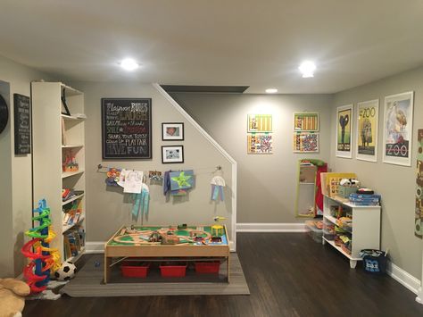 Basement Playroom decor reading area train table and puzzles Finished Basement Playroom, Unfinished Basement Playroom, Basement Play Area, Narrow Basement Ideas, Small Finished Basements, Home Daycare Ideas, Open Basement, Low Ceiling Basement, Daycare Decor