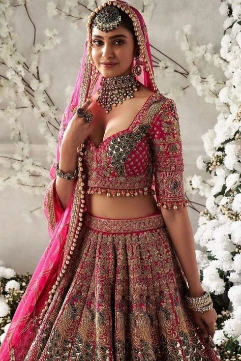 Planning to wear a pink bridal lehenga at your wedding? Here are 50+ bridal lehengas in all shades of pink to inspire you. Light Weight Bridal Lehenga, Bridal Lehenga Designs Latest Pink, Bridal Lehengas Indian, Bridal Lehenga For Wedding, Reception Blouse Design For Bride Pink, Bridal Lehenga Latest Designs, Bridal Lehenga Inspiration, Wedding Lehengas Bridal Pink, Lehenga For Wedding Brides