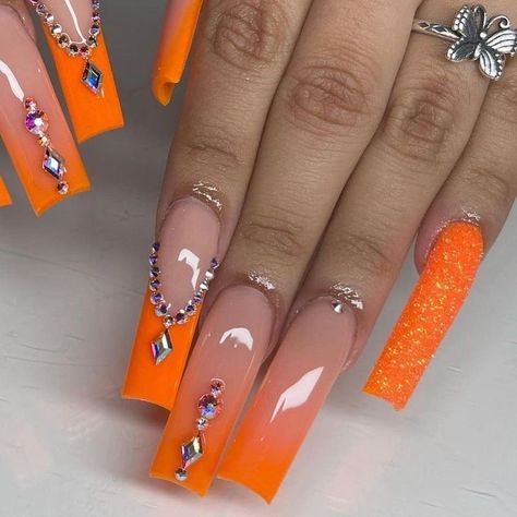 Long Orange Nails With Rhinestones, Yellow Glam Nails, Orange Nails With Jewels, Orange Xl Acrylic Nails, Orange Ombre Nails With Rhinestones, Nails Acrylic Designs Orange, Orange Bday Nails, Orange And Silver Nails Acrylic, Neon Orange Prom Nails