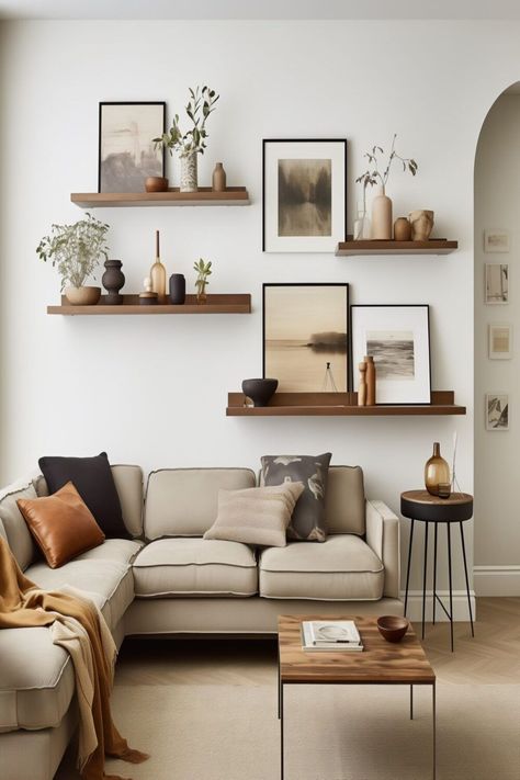 Shelf With Paintings, How To Hang Up Photos Wall Ideas, Couch Wall Art Ideas, Pictures On Wall Ideas Living Room Layout Floating Shelves, Plain Walls Ideas, Gallery Wall With Greenery, Plain Wall Living Room Ideas, Picture Wall Ideas Shelves, Sitting Room Wall Ideas