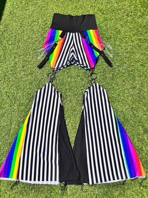 MTO= Made To Order  All pants come with side chains and spikes!  FIRE 🔥 SAFE MATERIAL B/W strip fabric and rainbow fabric is made from 95% cotton and 5% stretch polyester Black fabric is a bamboo organic cotton blend with 5% stretch polyester  This is what all fire preforms use!  The original Boofy the clown bell bottoms! This design was drawn by talented clown bestie then brought to life by yours truly!  These bells detach making them extra sassy and when the future comes you'll be able to swa Black And Rainbow Outfit, Absurdist Fashion, Ravecore Outfits, Oc Clothing Ideas, New Wave Outfits, Outfit Accessories Ideas, Weirdcore Fashion, Rainbowcore Fashion, Rainbow Suit