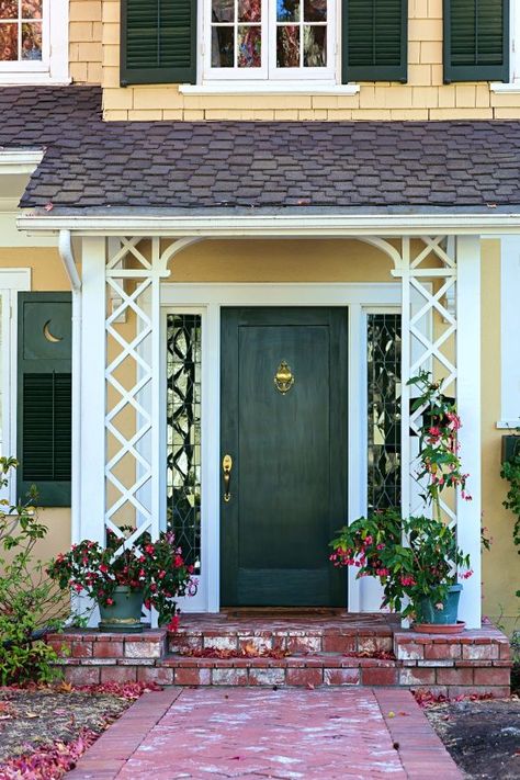 Green Front Door on Yellow Colonial Style Home Arches Facade, Dark Green Front Door, Green Home Exterior, Porch Trim, Green Front Door, Colonial House Exteriors, Cottages By The Sea, Green Front Doors, Lake Houses Exterior