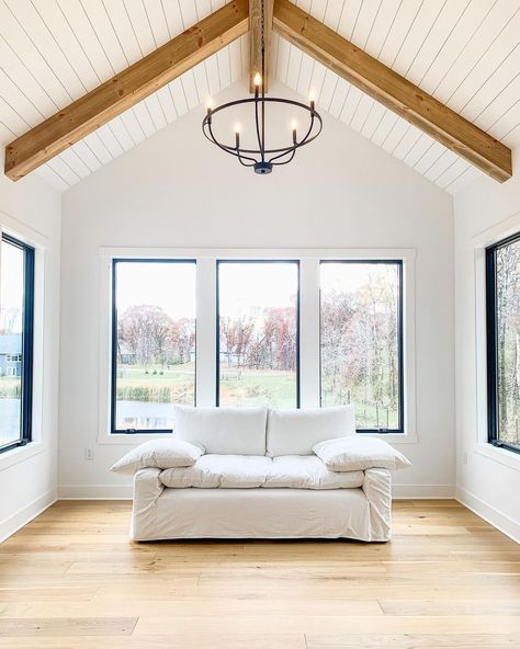 Trey Ceiling With Wood Beams, Wood Pitched Ceiling, Vaulted Ceiling Square Windows, Planked Ceiling With Beams, Black Picture Window, Vaulted Shiplap Ceiling, White Vaulted Ceiling, Shiplap Ceiling With Beams, Vaulted Ceiling Windows