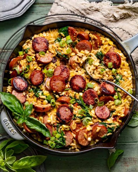 Creamy Cajun Orzo with Sausage (One Pan!) - Britney Breaks Bread Creamy Orzo With Crispy Chicken Sausage, Orzo Keilbasa, Andouille Sausage Orzo, Pasta With Chorizo Sausage, Cajun Kielbasa Recipes, Healthy Dinner Sausage, Sausage Jumbulyia Recipes, Jalapeno Cheddar Sausage Meals, Cajun Orzo Recipes