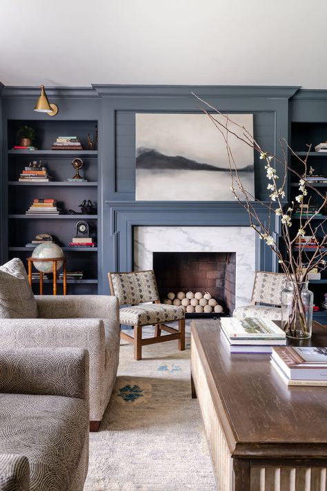 navy walls + living room design + living room inspiration + built-in bookcases + built-in storage + dark wood coffee table + artwork above the fireplace + marble fireplace | Parkes and Lamb Navy Living Room Walls, Navy Walls Living Room, Sitting Room Inspiration, Navy Living Room, Dark Wood Coffee Table, Bold Interior Design, Navy Living, Navy Living Rooms, Cozy Family Rooms