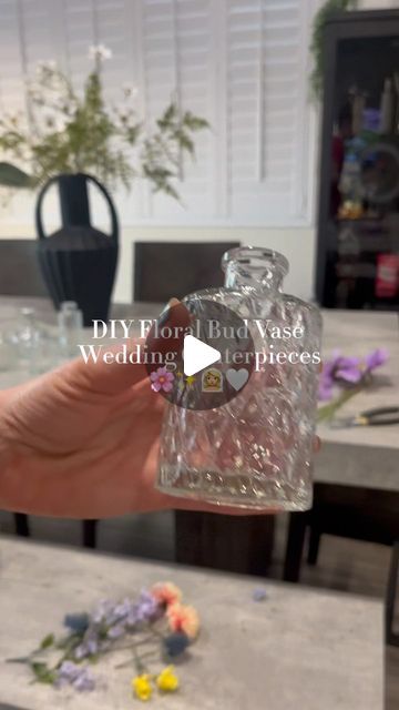 DIY With Jenna 🤍 on Instagram: "Floral bud vase centerpieces DIY ✨🌸🫶🏼  The most GORGEOUS way to include a splash of color without breaking the bank.  Pro tip: check out Facebook marketplace before buying bud vases! I’ve been seeing a ton of brides resell theirs there!  #diywedding #weddingcenterpieces #floralbudvase #budvasecenterpieces #diybride #summerbride #springbride #diyweddingdecor #diyweddingflowers #diywithjenna #weddingflowers #weddingflowerideas" Different Size Vases For Centerpieces, Bud Vase Centerpiece Ideas, How Many Bud Vases Per Table, Bud Vase Floral Centerpiece, Ribbon Vase Ideas, Mismatched Bud Vases Wedding, Center Piece Wedding Ideas, Vases With Water Beads Centerpiece Ideas, Diy Bud Vase Arrangement