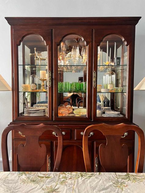 Dishes and glassware in wood china cabinet. Contemporary China Cabinet Display, Glass China Cabinet Display, Organizing China Cabinet Display, How To Style China Cabinet, China Cabinet Living Room, China Cabinet In Living Room, Dining Room With China Cabinet, Crystal Glassware Display, Curved Glass China Cabinet