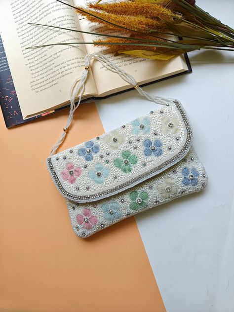 Introducing our Pastel Floral Embroidered Crossbody Bag, the perfect blend of elegance and functionality. Measuring 9"x5.5", this bridal clutch features a beaded strap and a magnetic closure, making it a unique and stylish accessory. Whether you’re looking for a bridesmaid gift or a perfect gift for mom, this floral crossbody clutch is sure to impress. Pastel Purse, Beaded Clutch Purse, Beaded Strap, Bridal Purse, Bridal Clutch, Beaded Handbag, Gifts Fo, Beaded Clutch, Crossbody Clutch