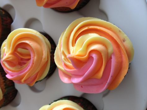 These are the cupcakes before the star topper. I love the "rainbow" frosting of pink, yellow and orange Pink And Orange Cupcake Ideas, Two Groovy Cupcake Ideas, Yellow And Pink Baby Shower Ideas, Groovy Cupcakes Ideas, Two Groovy Cupcakes, Pink And Yellow Baby Shower Ideas, Pink And Orange Cupcakes, Groovy Cupcakes, Teen Cupcakes