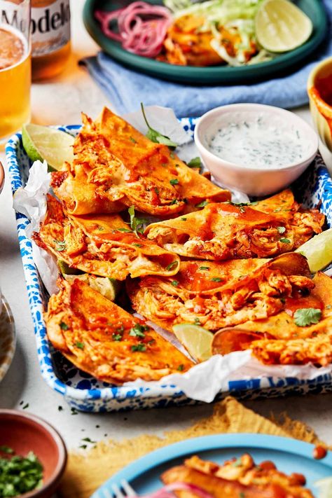 Totally craveable Crispy Buffalo Chicken Tacos! Stuff corn tortillas with tangy shredded buffalo chicken & cheese, then bake on a sheet pan until deliciously golden with crispy, cheesy edges. Serve with lots of toppings – blue cheese, ranch dressing, guacamole, salsa, you name it! – for an easy weeknight dinner or game day party snack. Ready in 35 minutes or less! #buffalochicken #buffalochickentacos #crispytacosrecipe #crispytacosinoven #superbowlpartyfood #gamedayfood #sheetpandinners Crispy Buffalo Chicken Tacos, Blue Cheese Ranch Dressing, Buffalo Chicken Sauce, Buffalo Sauce Recipe, Buffalo Chicken Tacos, Shredded Buffalo Chicken, Chicken Tacos Easy, Baked Chicken Tacos, Guacamole Salsa