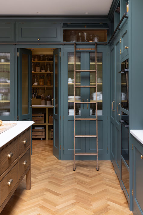 The tall run of cabinets is a striking and functional feature in this kitchen. At each end, the two double-door cupboards are dedicated crockery cupboards with fluted glass doors that open to reveal beautifully crafted oak interiors with matching oak shelves, perfect for organizing and displaying tableware. The two central doors are cleverly designed as 'secret doors' that lead directly into the walk-in pantry, blending seamlessly with the surrounding cabinetry. Tall Pantry Cupboard, Double Doors To Kitchen, Kitchen With Ladder, Pantry With Ladder, Fluted Glass Kitchen Cabinets, Tall Kitchen Cabinets Ideas, Full Height Kitchen Cabinets, Kitchen Tall Cabinet, Kitchen Glass Cabinets Display Ideas