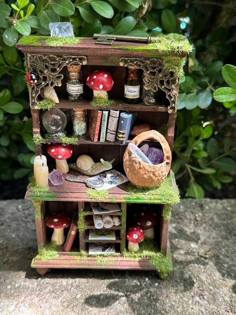 One of a kind fairy hutch - each hutch is a little work of art and contains its own special items.  Measures about 6.5 inches tall and 4 inches wide.  Each hutch I create is hand painted, has a crystal ball with a moving pattern, has hand created items, attention to detail,  contains real crystals/stones, are made with love and a little fairy magic. Fantasy Furniture Diy, Goblincore Furniture, Fairy Furniture Diy, Mushroom Furniture, Fairy House Ideas, Mushroom Stuff, Fairy Items, Fairy Dollhouse, Halloween Fairy Garden