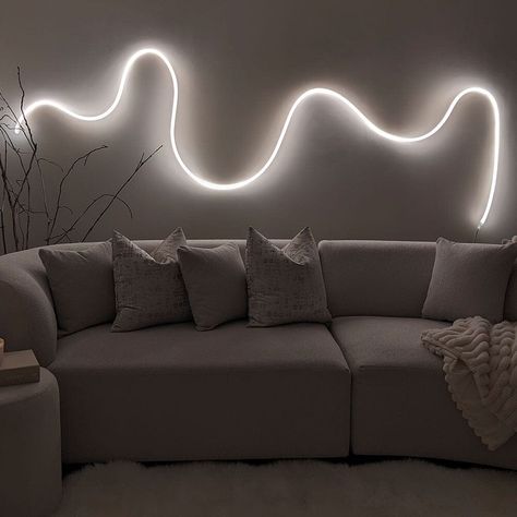 Warm white wall LED Rope light 5 meters in a luxury living room with a cream modern sofa. Led Wall Art Living Room, Curvy Led Light On Wall, Led Strip Wall Design, Led Squiggle Light, Squiggle Light On Wall, Led Rope Lights Living Room, Rope Lights Living Room, Led Rope Lights Bedroom, Neon Rope Light Ideas