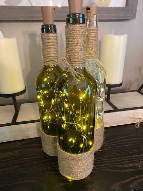 These wine bottles are filled with LED lights that look great as a center piece at your wedding or as home decor. Can be made with or without twine around the bottle. Wine Bottle Diy Wedding, Wine Themed Wedding Centerpieces, Wine Bottle Wedding Decor, Fall Wine Bottles, Reuse Wine Bottles, Bottle Art Projects, Wine Bottle Wind Chimes, Wine Bottle Centerpieces, Wedding Wine Bottles