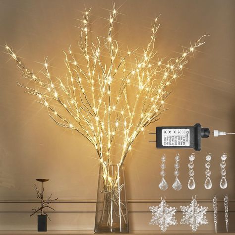 Embrace simplicity with clean lines and minimal clutter. Use a few carefully chosen statement pieces, such as a sleek tree or sculptural ornaments, to create a serene atmosphere. Lighted Branches Decor, Wedding Lighting Indoor, Tree Branch Decoration, Tree Branch Centerpieces, Lighted Tree Branches, Branch Centerpieces Wedding, Artificial Tree Branches, Branch Centerpieces, Twig Lights