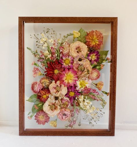 This is the perfect option for brides who have bouquets that are already dried! I can also use fresh flowers to create these frames. This frame is a high quality solid wood frame in a dark walnut finish. It measures 11x14 inches. The Process: 1.Message me prior to purchasing to reserve your date and inquire about availability.  2.Ship me your flowers! Detailed instructions on how and where to ship them will be sent to you once your reservation is made. I will also send a link to an information sheet that should be printed and included in the box with the flowers. Your flowers can be fresh or previously dried for this frame!  3.I will message you to let you know when your flowers arrive safely. If you send fresh flowers, they will dry over 8-10 weeks on my flower press, and I will watch ove Framed Pressed Flowers Wedding Bouquets, Bouquet Frame Dried Flowers, Pressed Flower Shadow Box Ideas, Framed Wedding Flowers, Pressed Floral Bouquet, Pressed Flowers Wedding Bouquet, Best Flower Press, Pressed Flower Frame Ideas, Diy Bouquet Preservation