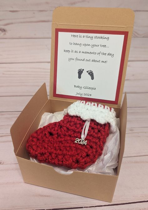 "This listing is for a cute little gift box for a Christmas pregnancy reveal. It has a handmade tiny red Christmas stocking with a sweet little card.  The stocking comes with a charm of your choice (available options are 2022, 2023, 2024 and snowflake).  Whoever opens this reveal box will see the card as it will be taped to the underside of the lid. Then they will see the cute little stocking and get a big surprise!   The length of the stocking is about four inches and the gift box is 4 inches l I’m Pregnant Surprise Grandparents, Baby Reveal Ideas Christmas, Christmas Present Baby Announcement, Christmas Ornament Pregnancy Reveal, Christmas Baby Announcement To Parents, Pregnancy Announcement At Christmas To Family, Christmas Pregnancy Announcement Grandparents, Christmas Theme Pregnancy Announcement, Christmas Gift Baby Announcement