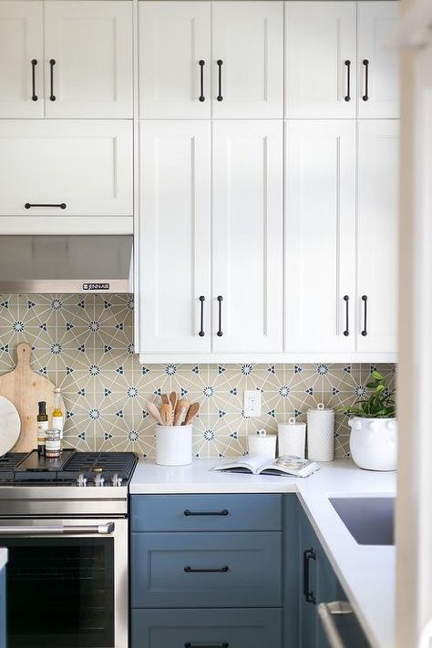 Blue kitchen drawers accented with oil rubbed bronze pulls and a white quartz countertop fixed against beige and blue mosaic backsplash tiles. Blue Lower Kitchen Cabinets, White Upper Cabinets, Top Kitchen Cabinets, White Cupboards, Bronze Pulls, White Shaker Kitchen, Blue Kitchen Cabinets, White Shaker Cabinets, Shaker Kitchen Cabinets