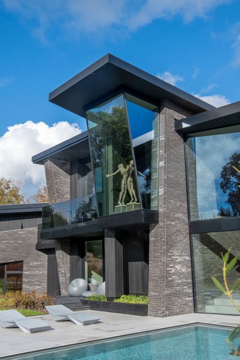 Structural glass to luxury dwelling leans at an angle forming a remarkable piece of architectural glazing Glass Modern House, Villain House, Modern Glass House, Glass House Design, 1st May, Independent House, Glass Structure, Glass Installation, Concrete House