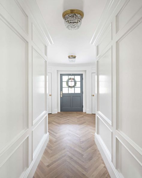 Herringbone flooring and beautiful paneled walls painted Benjamin Moore Simply White. The Fox Group. #benjaminmooresimplywhite #interiordesign #thefoxgroup The Fox Group, Benjamin Moore Simply White, Fox Group, Projek Diy, Timeless Interior Design, Foyer Entrance, Herringbone Wood Floor, Herringbone Wood, White Oak Hardwood Floors