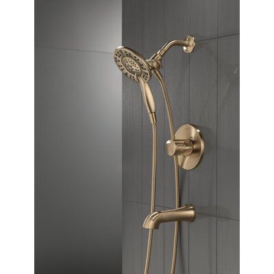 Inspired by modern architecture, the Albion Collection brings dimensional style to your bath with a soft touch of curves rooted in angular geometries. The Delta® In2ition® Two-in-One Shower features a detachable hand shower that can be used separately from or simultaneously with the shower head. This integrated dual-functionality gives you maximum flexibility without sacrificing warmth, as you can choose to have water streaming from the shower head only, the hand shower only, or both the shower Champagne Bronze Shower Fixtures, Bronze Shower Fixtures, Shower Fixtures, Shower Faucet Sets, Tub Shower, Champagne Bronze, Tub And Shower Faucets, Bathtub Shower, Trim Kit