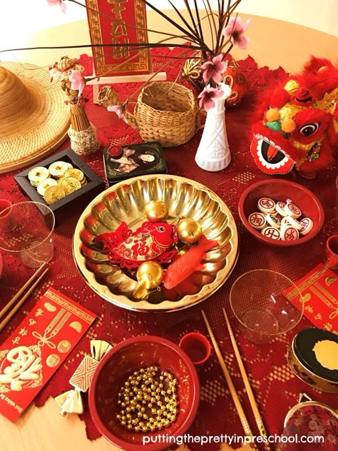 A Lunar New Year tablescape filled with Asian artifacts and red and gold loose parts for little learners to explore. New Year Tablescape, Chinese New Year Table, Chinese New Year Traditions, Chinese New Year Activities, Chinese Theme, New Year Table, Spain Food, New Years Activities, New Year's Food