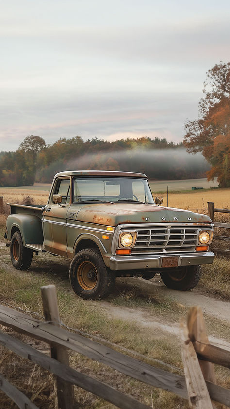 A weathered vintage Ford pickup truck in faded green and rusty hues parked by a wooden fence in a pastoral farm setting, with autumn trees and misty fields in the background, evoking a sense of rustic Americana. 1960 Ford Truck, Vintage Pick Up Trucks, Vintage Farm Truck, Old Pick Up Trucks, Old Truck Aesthetic, Old Ford Trucks Vintage, Old Farm Truck, Old Truck Photography, Old Ford Pickups