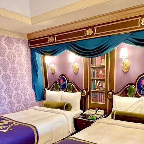 Disney Food Blog on Instagram: "It’s time for HER! ✨🌹✨🌹 The 💙💛Beauty and the Beast themed hotel room💛💙 is the biggest and most detailed of all the character rooms we booked at the Disneyland Hotel in Tokyo Disney! Check out the details: 📚 That library wallpaper in the front entrance hall!!!! 😍 All of the books are Disney stories in French. 🏰 Stained glass detail on bathroom doors 💛 Belle’s dress ruffles as the bed skirt 🕯️Cogsworth and Lumiere silhouettes in the main purple wallpaper 🐶 Sultan ottoman at the desk And so much more! It’s so beautiful! Swipe for a full walkthrough! 👉👉👉" Disney Hotel Aesthetic, Disney Hotel Room, Disney Hotels Room, Sultan Ottoman, Library Wallpaper, Themed Hotel Rooms, Hotel In Tokyo, Disney Hotel, Dress Ruffles