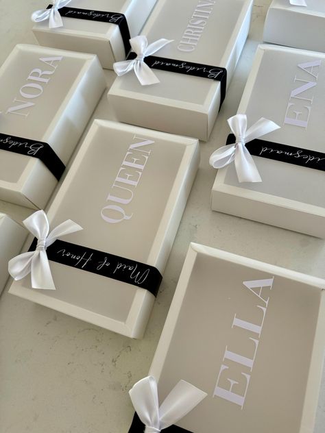 Personalized bridesmaid proposal gift boxes. These custom bridesmaid gift boxes come with a frosted sleeve that slides on and off exposing all the items inside.  These custom boxes are fabulous for bridal shower gifts, bridesmaid proposal gift boxes, bachelorette party favor gift boxes, maid of honour thank you gift boxes, Wedding favor boxes, birthday gift boxes or as a wedding welcome package for your guests. These gift boxes are a great medium size and fit a variety of items.  Complete with a Preppy Bridesmaid Proposal, Black Bridesmaid Proposal Boxes, Luxe Bridesmaid Proposal, Bridesmaid Proposal Useful, Unique Bridesmaid Boxes, Wedding Day Gifts For Bride, Will You Be My Bridesmaid Boxes, Brides Made Proposals, Bridesmaids Day Of Gifts