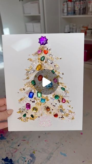 CHELSEA BAUGH on Instagram: "✨🎄By popular demand here’s your “Colorful Over The Top” Christmas tree tutorial🎄✨ I made these for an activity with young girls from my church and it was a hit! Have so much fun making these with your littles!! And remember too much color and glitter is never enough😘! Tag #chelsmadetree so we can see your happy trees!! 🎨Supplies: (you will find everything at hobby lobby or Michaels) -Canvas panels 8x10” or 11x14” -Acrylic paint. Choose your favorite colors!! -flatback gems -fabric paint to use as garland -@chelsmadesupplies ‘Round and Fan’ paint brush. -clear glitter and any other glitter colors! -decoart glitter paint. P.s. Be sure to just plop the paint on nice and thick! This way you won’t need any glue and your gems will dry into your glue along Painting Christmas Pictures On Canvas, How To Make Jeweled Christmas Trees, Gem Christmas Tree, How To Paint A Christmas Tree On Canvas, Glitter Art For Kids, Michaels Canvas, Diy Christmas Paintings On Canvas, Glitter Painting Canvas, Glitter Glue Crafts