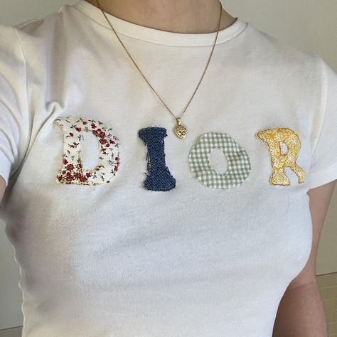 I might be biased but you should probably buy this on Depop 👍 https://depop.app.link/cEJ9wyBNMyb Fabric Letter Shirt, Letter Tshirt, Sewn Letters On Shirt, Patchwork Letter Shirt, Diy Baby Tee Ideas, Sewing Letters On Fabric, Patchwork Baby Tee, Diy Baby Tee, Embroidery Tshirt Ideas