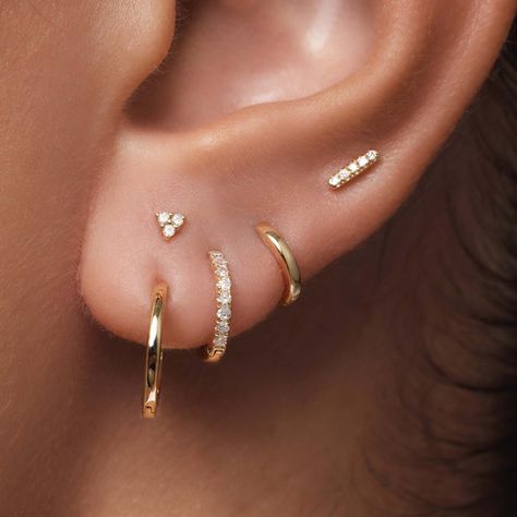 The Single Huggie (12mm) is the perfect basic for any ear stack. Made of 14 karat gold.  Per piece Ear Piercing Simple Ideas, Piercing Ideas 3 Holes, Bride Earrings Multiple Piercings, Single Ear Piercing Ideas, Ear Piercing Ideas Dainty, Stacked First Lobe Piercing, 3 Lobe Earring Stack, 3 Percinings Ear Ideas, Ear Piercing Ideas Both Ears