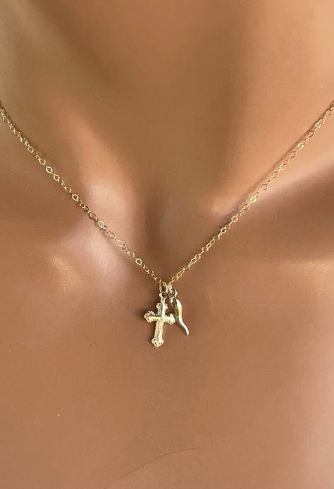 "This is a 925 Sterling silver or 14kt Gold-filled Tiny Italian horn and cross double charm necklace on a 14kt Gold-filled shiny chain.  The Italian Horn is also known as the  \"Cornetto\" or \"Cornicello\" .  This is truly a little treasure she will love forever! Necklace chain is is shiny gold and catches light with movement. The entire necklace is 14kt gold-filled or 925Sterling silver.  This is a very small dainty horn that measures Horn pendant measures 14x2mm, cross measures 15x7mm.  Neckl Italian Horn Necklace, 14kt Gold Jewelry, Italian Necklace, Italian Pride, Forever Necklace, Italian Horn, Clean Sterling Silver, Gold Horns, Horn Necklace