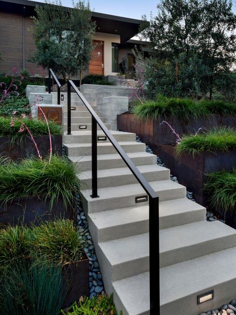 Modern Outdoor Stair Railing Ideas, Retaining Wall Stairs With Railing, Outdoor Entry Stairs, Modern Exterior Stairs, Black Outdoor Railing Front Porches, Modern Exterior Handrail, Modern Handrails For Stairs Outdoor, Exterior Handrail Design, Retaining Wall Railing