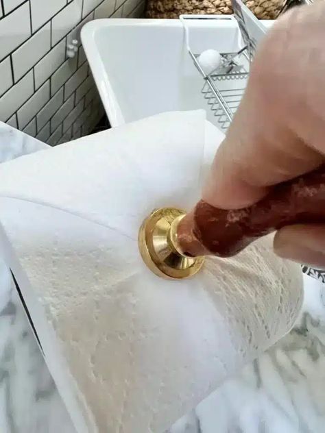 Pressing an embossing tool into the end of a roll of toilet paper. Embossed Toilet Paper, Toilet Paper Embossing, Toilet Paper Stamping, Spare Toilet Paper Holder Ideas, Toilet Paper Folding Ideas, Toilet Paper Stamp, Toilet Paper Origami, Hotel Cleaning, Jetted Bath Tubs