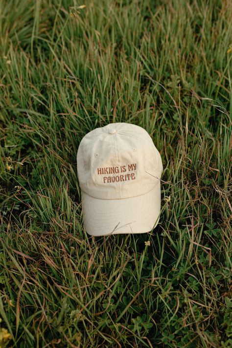 Take a hike and bring your favorite new hat with you! Hat Merch Photoshoot, Product Photography Accessories, Hat Advertising Photography, Baseball Hat Photography, Hat Branding Ideas, Cap Photoshoot Ideas, Sombreros Aesthetic, Hat Product Photography, Baseball Hat Aesthetic