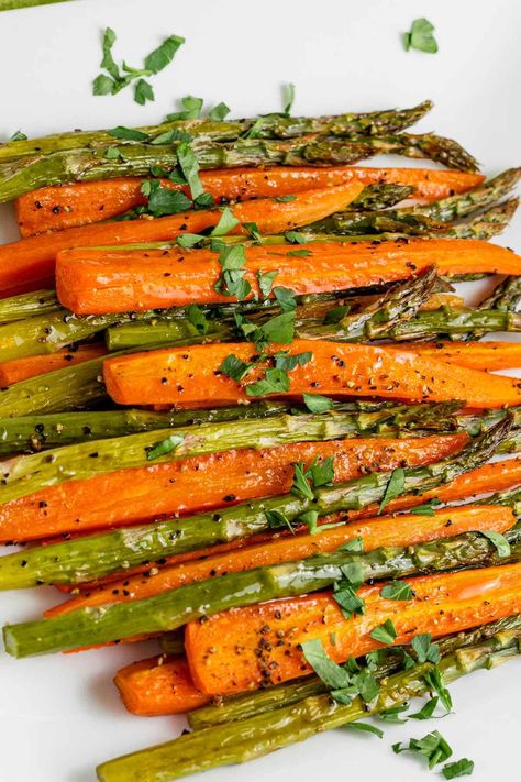 Roasting carrots and asparagus together in the oven is quick and delicious! This recipe is an easy side dish that pairs with array of dishes. Serve the vegetables with lemon wedges and grated parmesan. Roasted Carrots And Asparagus, Asparagus In The Oven, Easy Roasted Carrots, Carrots And Asparagus, Oven Roasted Asparagus, Baked Asparagus, Roasted Vegetable Recipes, Cooked Carrots, Roasted Asparagus