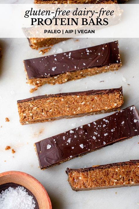 These are the Best Gluten-Free Dairy-Free Protein Bars! They’re soft and fluffy, packed with fiber and protein, and topped with a smooth chocolate coating. These homemade, no-bake paleo protein bars are vegan- and Modified AIP-friendly. They’re the perfect grab-and-go snack or wholesome treat! #proteinbars #glutenfreedairyfreerecipes #glutenfreeproteinbars #dairyfreeproteinbars #paleoproteinbars #nobakeproteinbars #soyfreeproteinbars #veganproteinbars #aipproteinbars #diyproteinbars Raw Protein Bars Recipe, Vegan Protein Bars Homemade, Paleo Protein Bars Homemade, Paleo Protein Bar, Aip Protein Snacks, Gluten Free Protein Bars Homemade, Paleo High Protein Snacks, Sugar Free Protein Bars Homemade, Homemade Healthy Protein Bars