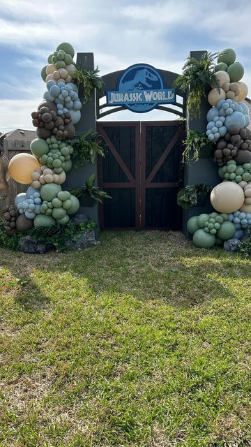 Over the Top Party Events on Instagram: "What a DINOmatic setup??🦖☄️ •#overthetopballoondecor #overthetoppartyevents #balloongarland #juarassicworld #dinosaur #dinosaurparty #dinosaurprops #lifesizeprops" Dinosaur Party Entrance, Jurassic Park Balloon Decor, Fancy Dinosaur Party, Cowboy Dinosaur Party, Jurassic Park 1st Birthday Party, Jurassic Park Balloon Garland, Diy Jurassic Park Decorations, Dinosaur Balloon Decorations, Dino Balloon Garland