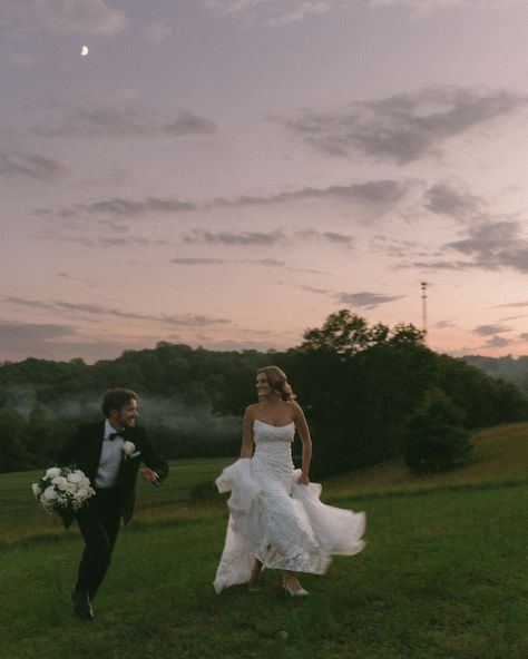 Bride and groom running under the moonlight together. Beautiful wedding photos at night. Wedding photos with the colorful dark sunset. Bright moon in the sky. Running in the grass under moonlight. Candid wedding photography. Wedding Pictures At Night, Wedding Running Photo, Bride And Groom Candid Photos, Wedding Photos Running, Wedding Photos On The Beach, Late Night Wedding Photos, Wedding Photo Ideas Candid, Night Time Wedding Photos, Candid Wedding Photos Natural