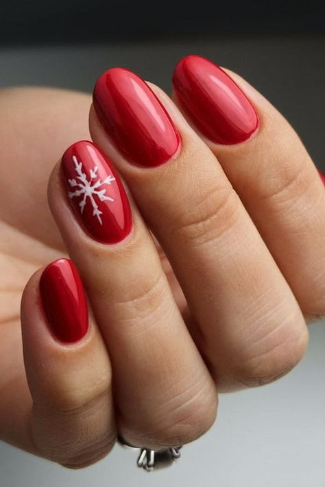 A simple yet elegant red nail design with a white snowflake on the ring finger, perfect for the holiday season. The glossy red finish adds a vibrant touch, while the snowflake art brings in the winter spirit. Red Nails With Snowflake, Nails With Snowflake Design, Red Nail Design, Snowflake Art, Snowflakes Art, Ring Finger Nails, Red Christmas Nails, Holiday Nail Designs, Christmas Nails Easy