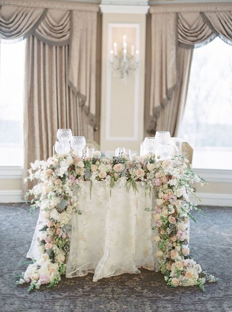 The bride and groom sat at a fairy-tale sweetheart table covered with an embroidered linen and decorated with a garland of muted blooms and greenery that fell … Regal Decor, Sweetheart Table Flowers, Weddings Elegant, Sweetheart Table Decor, Oheka Castle, Fair Photography, Wedding Doors, Sweetheart Table Wedding, Reception Inspiration