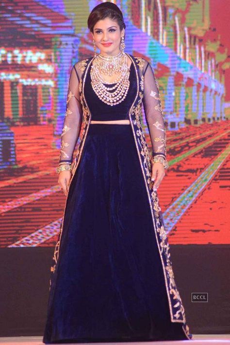 Raveena Tandan in Navy Blue Velvet Lehenga Choli with Long Jacket at IBJA Fashion Show Blue Velvet Lehenga, Bollywood Actress Saree, Velvet Lehenga Choli, Navy Blue Gown, Raveena Tandon, Velvet Lehenga, Indian Women Fashion, Floral Frocks, Lehenga Designs Simple