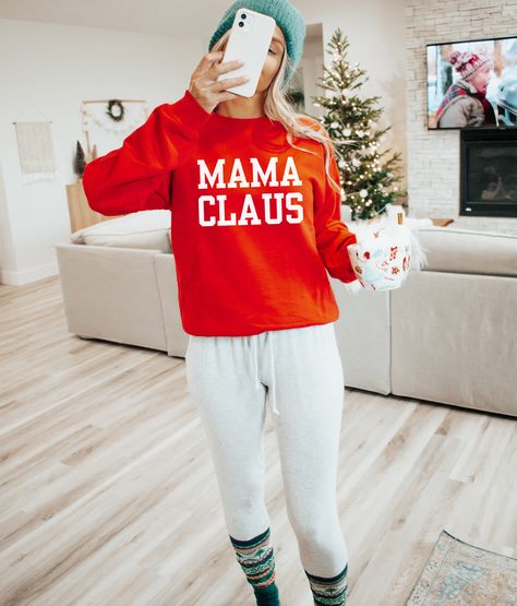 Get into the holiday spirit with our Mama Claus sweatshirt, the ultimate Christmas must-have for moms. Crafted from a super soft and cozy material, this sweatshirt guarantees a snug fit and all-day comfort. Perfect for festive gatherings or snuggling up by the fire, it's the ideal companion during the most wonderful time of the year. Embrace the magic of Christmas in style, and let the world know you're a proud Mama Claus, spreading love and warmth with every wear. Unisex fit Stay with your true Mama Claus Sweatshirt, Ultimate Christmas, Oversized Graphic Tee, Mama Tee, Trendy Graphic Tees, Mama Sweatshirt, Christmas Mom, Holiday Shirts, Mama Shirt