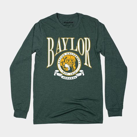 Though it would be pretty cool, Baylor University’s seal isn’t actually a bear holding a football. This “seal” is actually a recreation from a vintage pennant we found, and we added some more collegiate flourishes to give a nod to vintage college apparel and merch of yore. Brought to you in partnership with College Vault. Products are mocked up on a size S. Graphics may appear smaller on larger sizes. Vintage College Shirts, Football Crest, Baylor Football, College Apparel, Vintage College, University Tshirt, Baylor University, College Shirts, Identity Design Logo