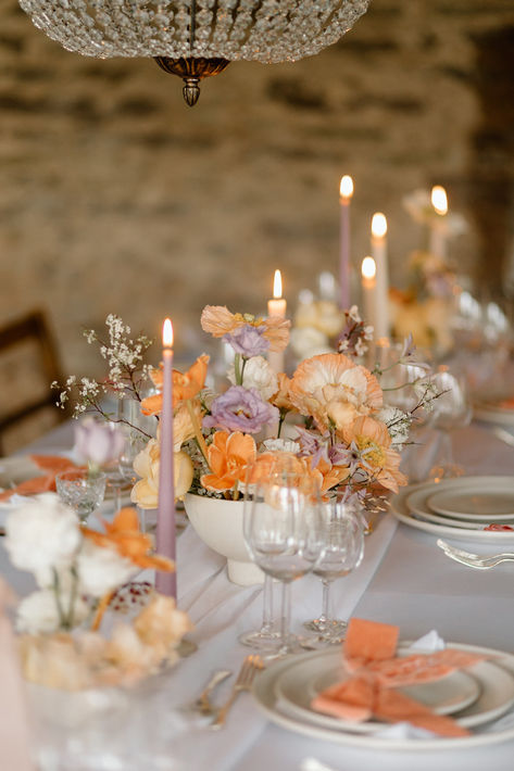 White bowl wedding table centrepiece with lilac and peach wedding flowers with peach and lavender candles decorating the tablescape | wedding table decor | wedding flowers | Kirsty Louise Photo Wedding Theme Lilac, Lavender And Citrus Wedding, Peach And Purple Wedding Flowers, Lilac Wedding Inspiration, Mauve Peach Wedding, Peach And Lilac Wedding Flowers, Wedding Decor Peach, Rust And Lilac Wedding, White And Purple Wedding Flowers