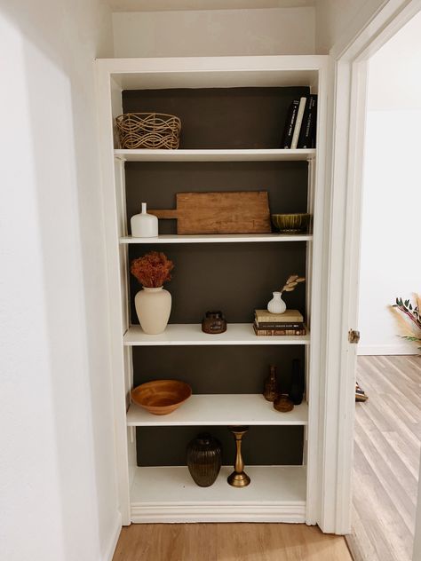 Hallway, bookshelf styling, bookshelf decor ideas, black paint, neutral decor Shelves At End Of Hallway, End Of Hallway Bookcase, End Of Hallway Storage, Hall Bookshelf Ideas, End Of Hall Bookshelf, End Of Hallway Shelves, End Of Hallway Bookshelf, Backless Bookshelf, Shelf In Hallway