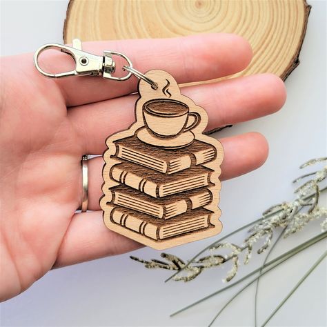 For all my book and coffee lovers, this keychain was made just for you! It is sure to be a conversation starter with any fellow bibliophile. This adorable keychain is engraved in-house using sustainable American hardwood. After your new keychain is engraved, it is finished with a silver lobster clasp keychain so you can attach it to your keys, backpack, and more! Best of all, this product is all-natural, so you can feel good about shopping small AND eco-friendly today! Material: Beech hardwood, Wooden Keychain Ideas, Book And Tea, Wood Engraved Gifts, Coffee Keychain, Book And Coffee, Keychain Wood, Wood Laser Ideas, Laser Cut Wood Crafts, Laser Engraved Ideas